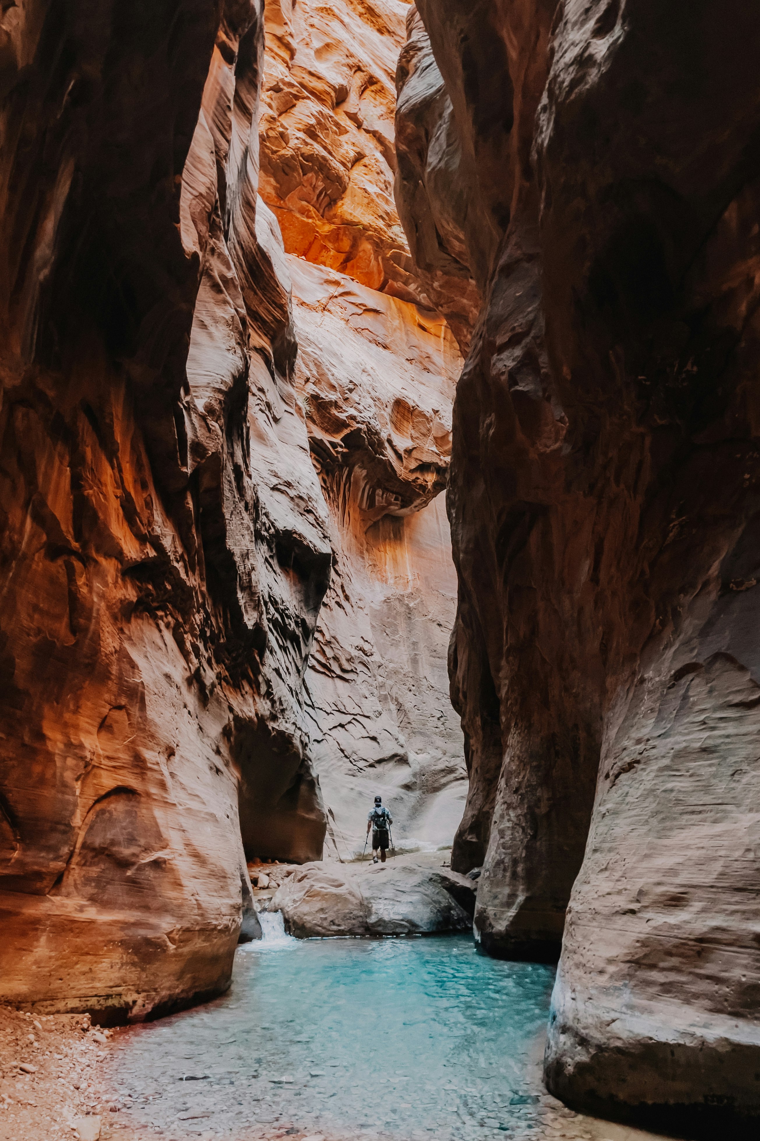 person in black jacket sitting on rock formation during daytime